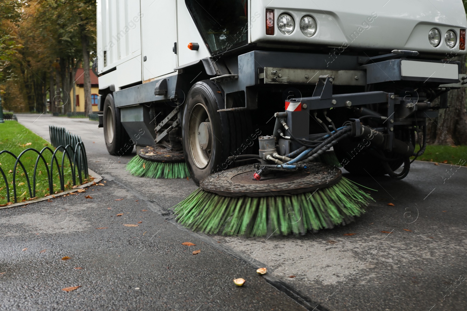 Photo of Sweeping car in park on autumn day