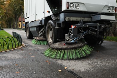 Sweeping car in park on autumn day