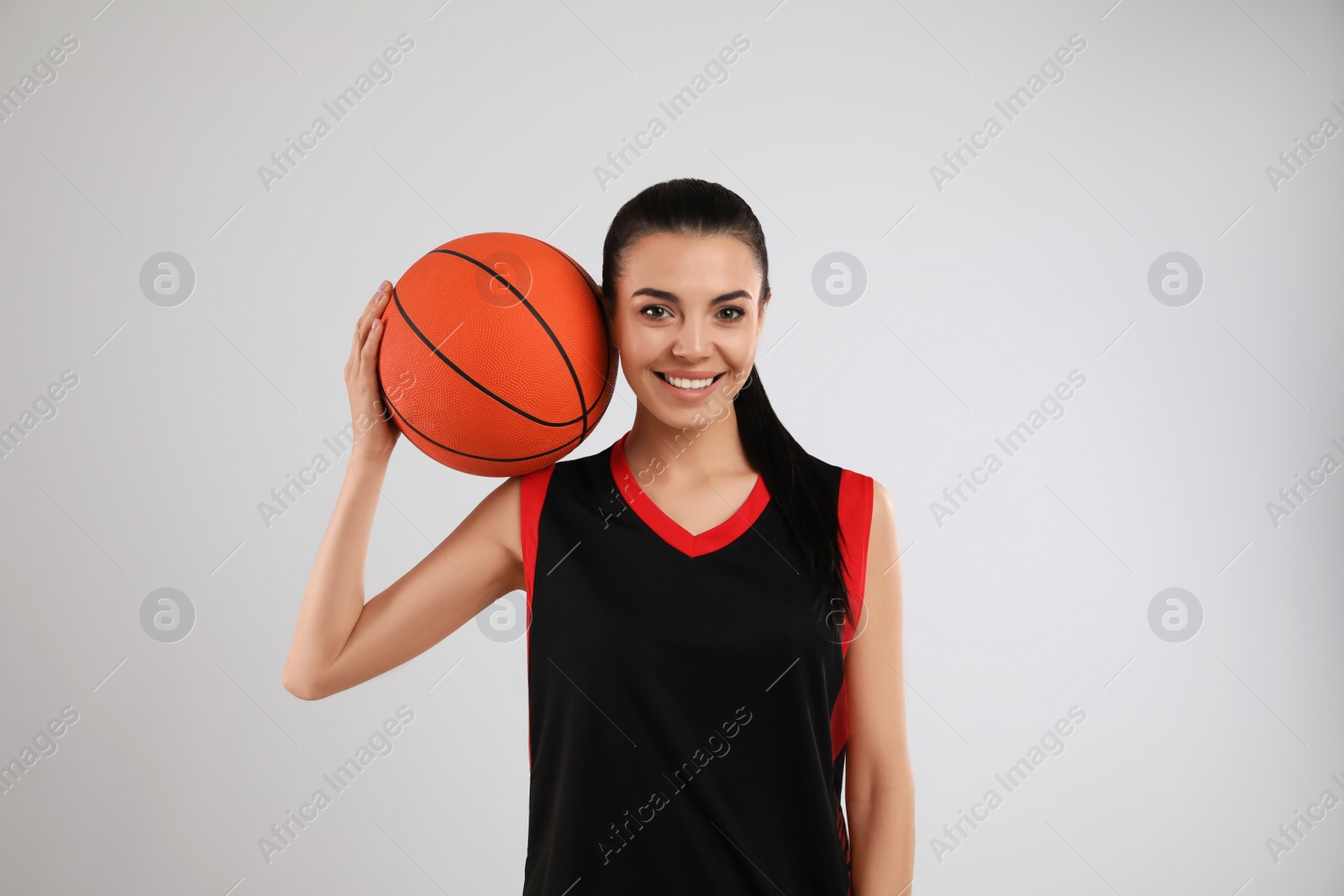 Photo of Basketball player with ball on grey background