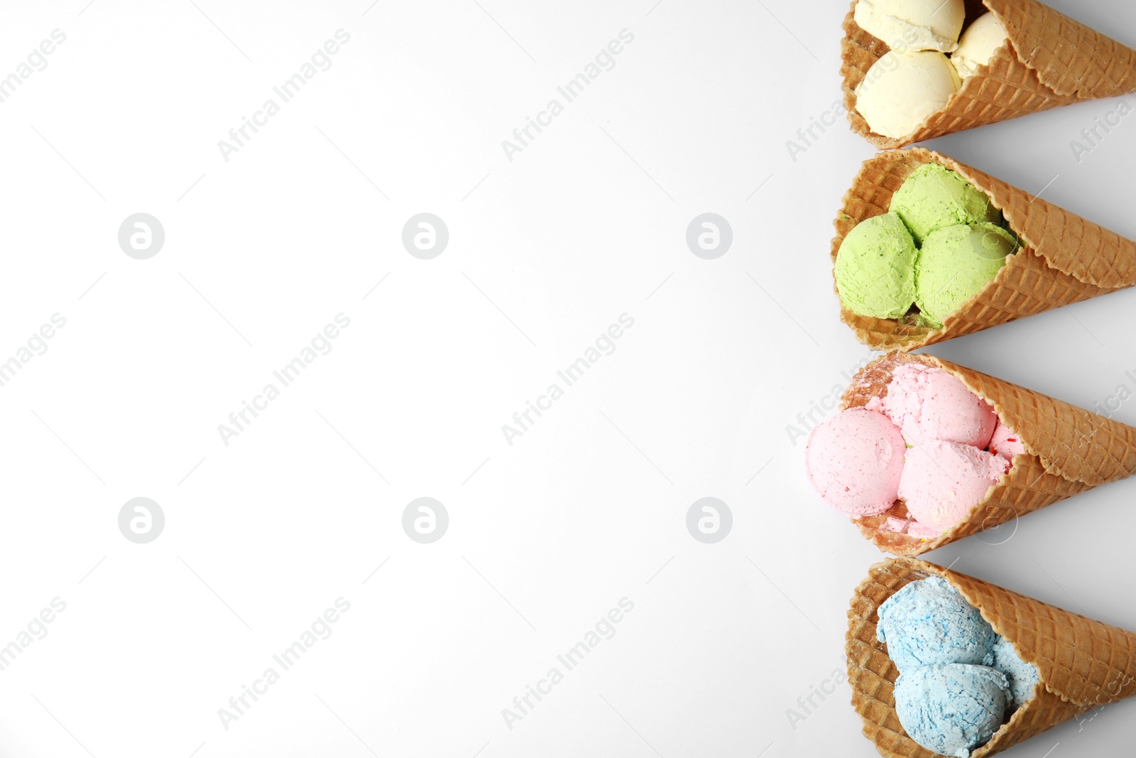 Photo of Composition with delicious ice creams in waffle cones on white background, top view