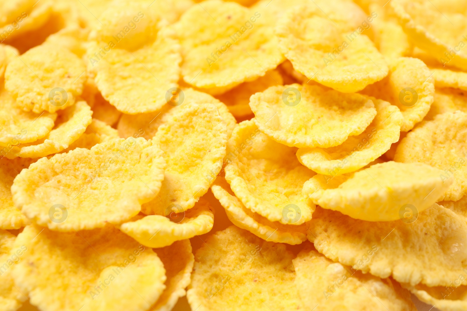 Photo of Tasty crispy corn flakes as background, closeup