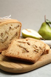 Photo of Tasty pear bread on light grey marble table, closeup. Homemade cake