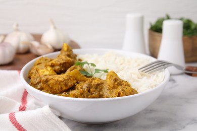 Photo of Delicious chicken curry with rice on white marble table, closeup