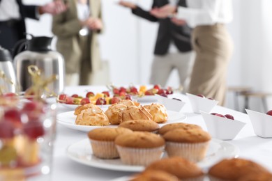 Table with different delicious snacks indoors. Coffee break