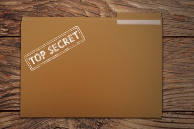 Image of File with documents and Top Secret stamp on wooden table, top view