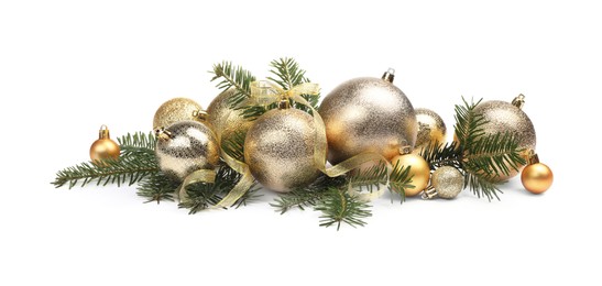 Many golden Christmas balls, ribbon and fir twigs isolated on white