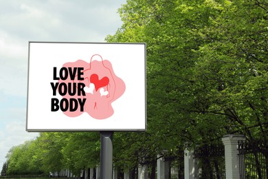 Signboard with outline of woman figure, hearts and phrase Love Your Body on city street
