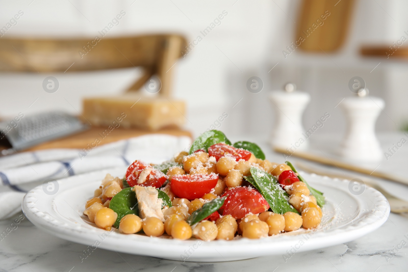 Photo of Delicious fresh chickpea salad on white marble table
