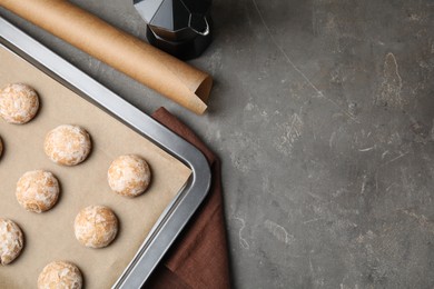 Photo of Tasty homemade gingerbread cookies on grey table, flat lay. Space for text