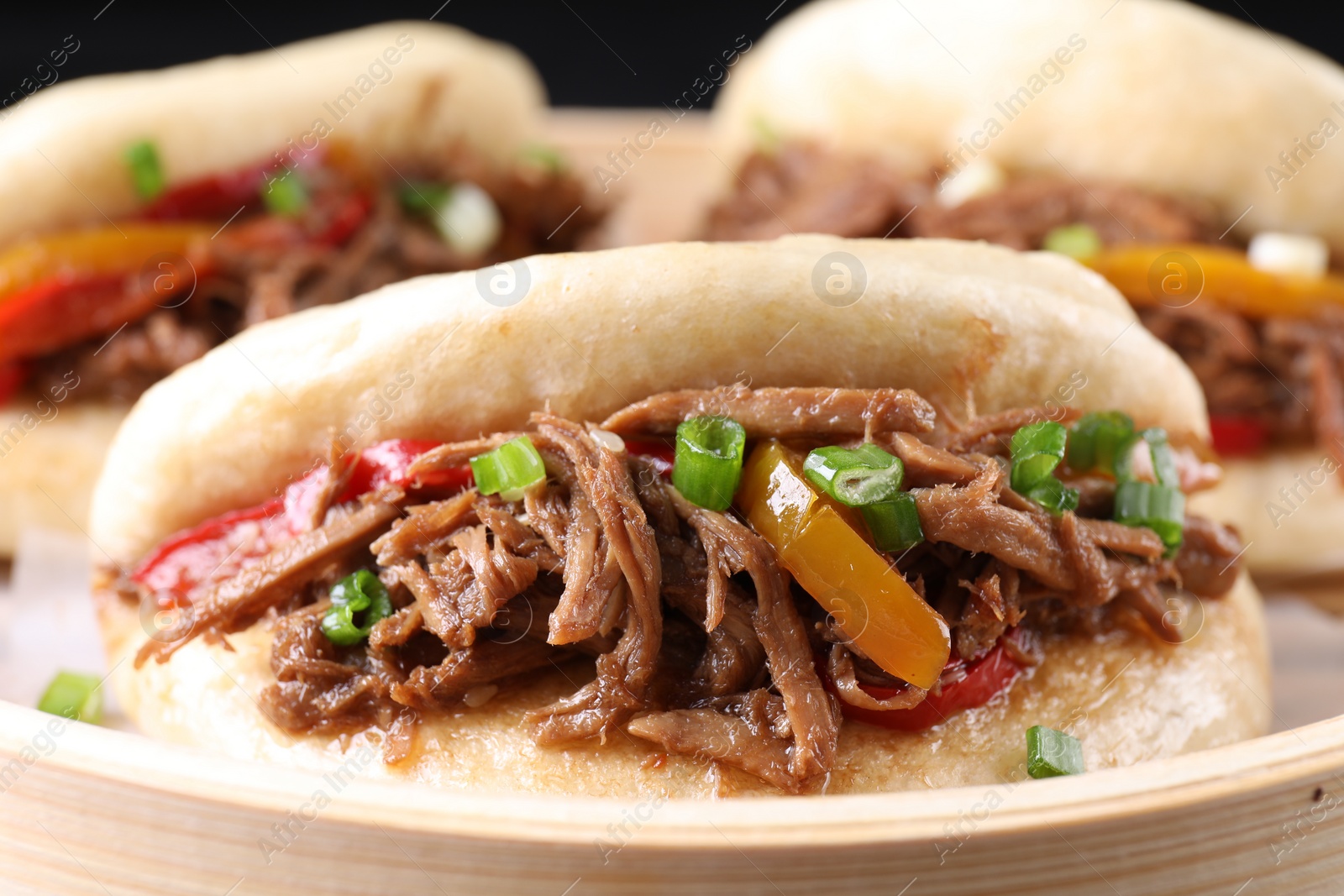 Photo of Delicious gua bao in bamboo steamer, closeup