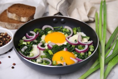 Photo of Tasty Shakshouka served on white marble table, closeup