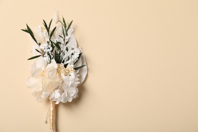 Stylish boutonniere on beige background, top view. Space for text