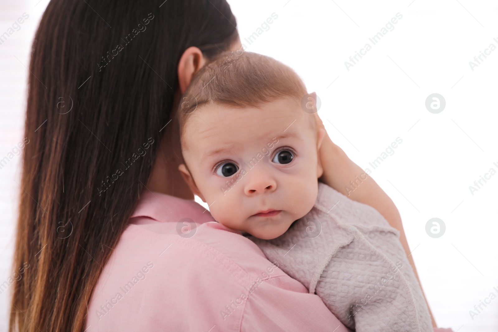 Photo of Young woman with her cute baby on white background
