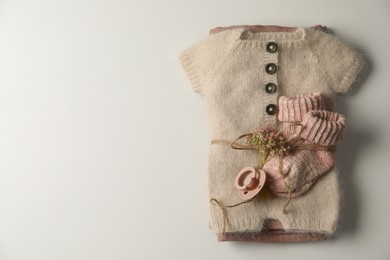 Photo of Set of baby clothes and accessories on light background, top view. Space for text