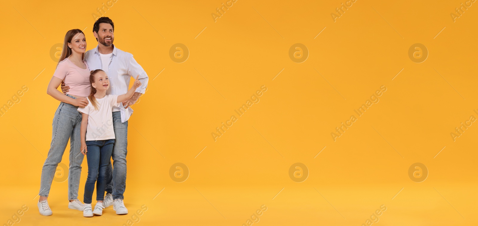 Image of Happy family with child on orange background, space for text. Banner design