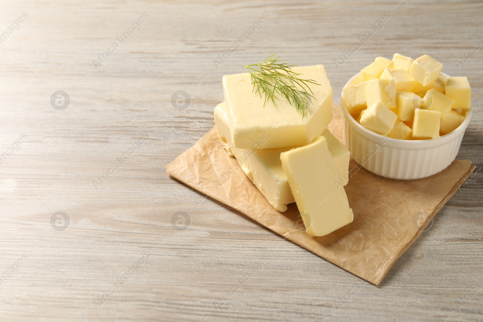 Photo of Tasty butter with dill on wooden table. Space for text