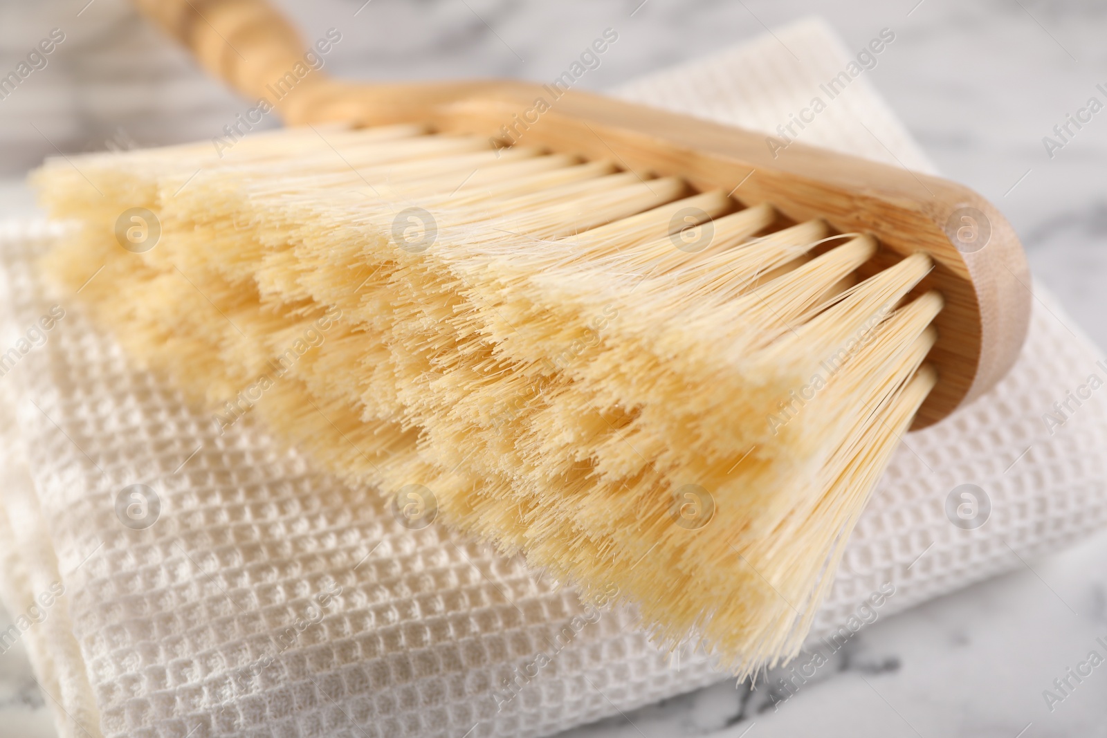 Photo of One cleaning brush and rag on table, closeup