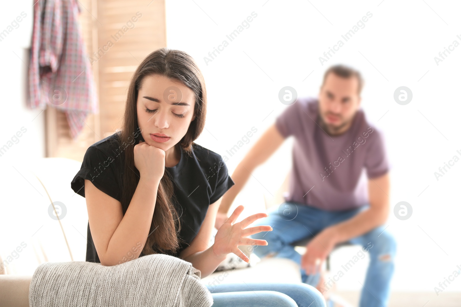 Photo of Young couple having argument in living room