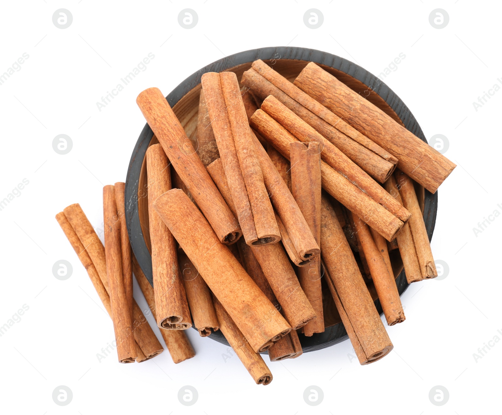 Photo of Bowl with aromatic cinnamon sticks on white background