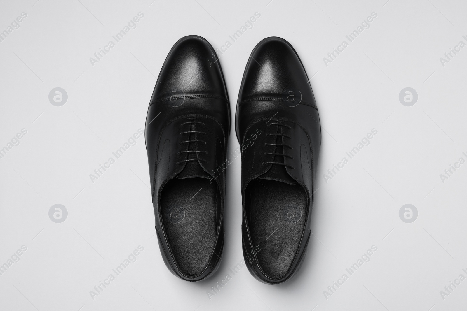 Photo of Pair of leather men shoes on white background, top view