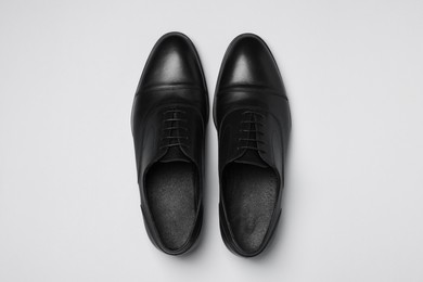 Photo of Pair of leather men shoes on white background, top view