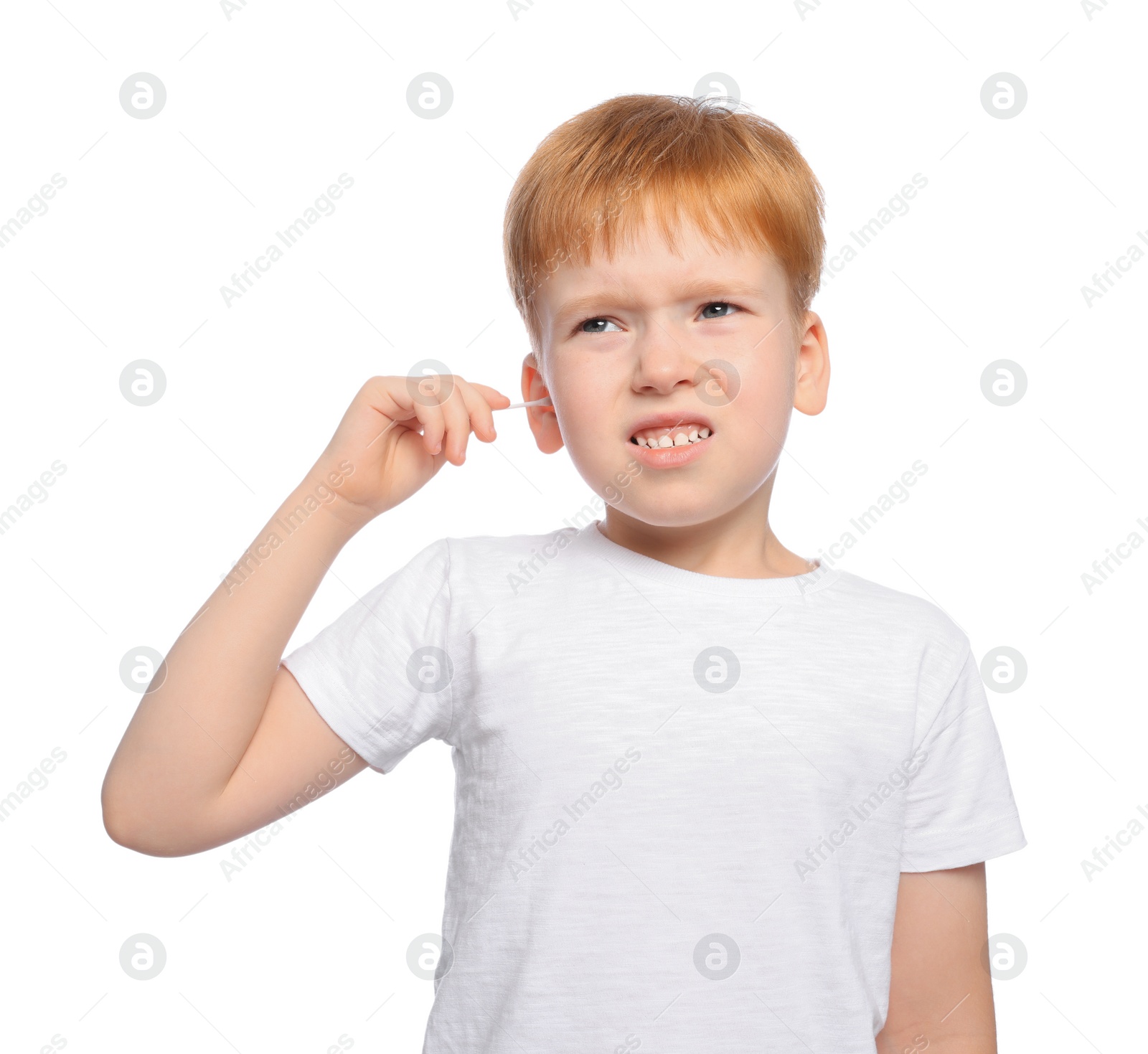 Photo of Little boy cleaning ear with cotton swab on white background