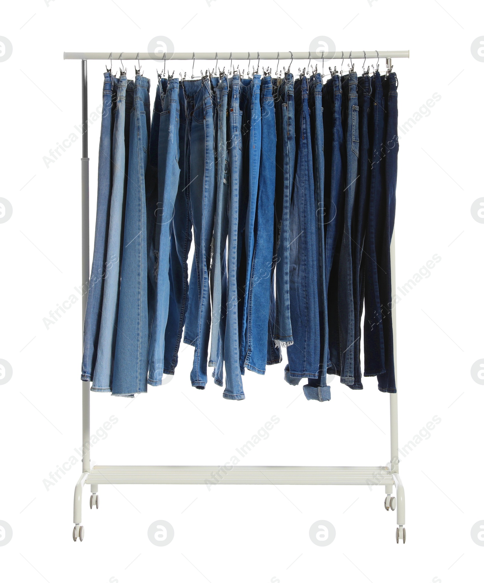 Photo of Rack with different jeans isolated on white