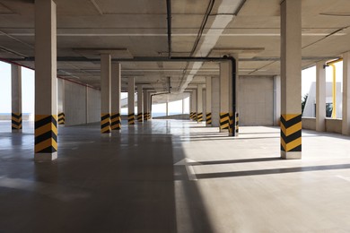 Photo of Empty open car parking garage on sunny day