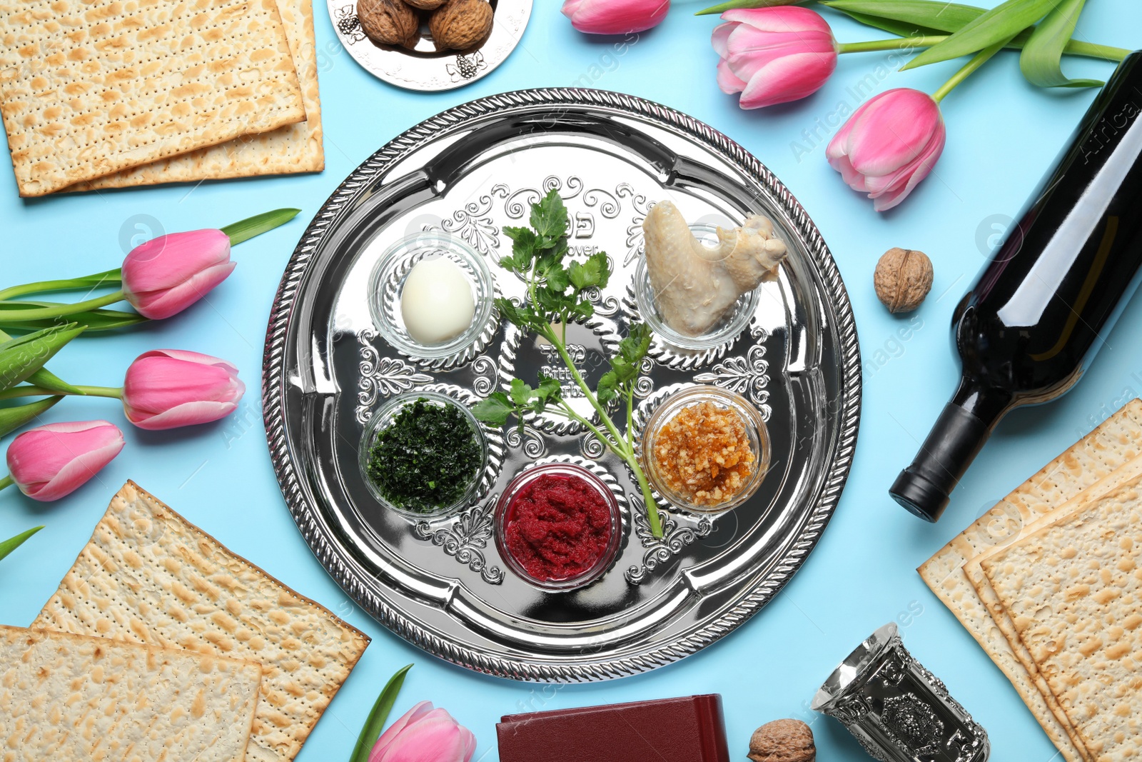 Photo of Flat lay composition with symbolic Passover (Pesach) items and meal on color background