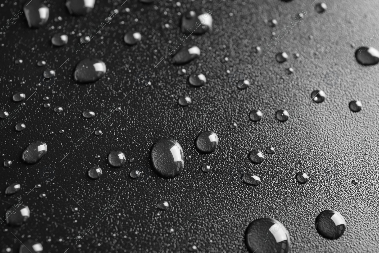 Photo of Many clean water drops on black background