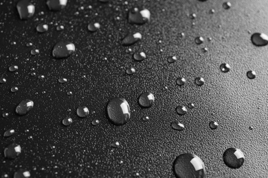 Photo of Many clean water drops on black background