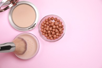 Photo of Applying face powder on brush on pink background, flat lay. Space for text