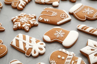 Photo of Different Christmas gingerbread cookies on grey background, closeup