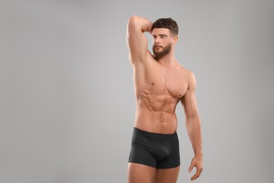 Photo of Handsome muscular man on light grey background. Sexy body