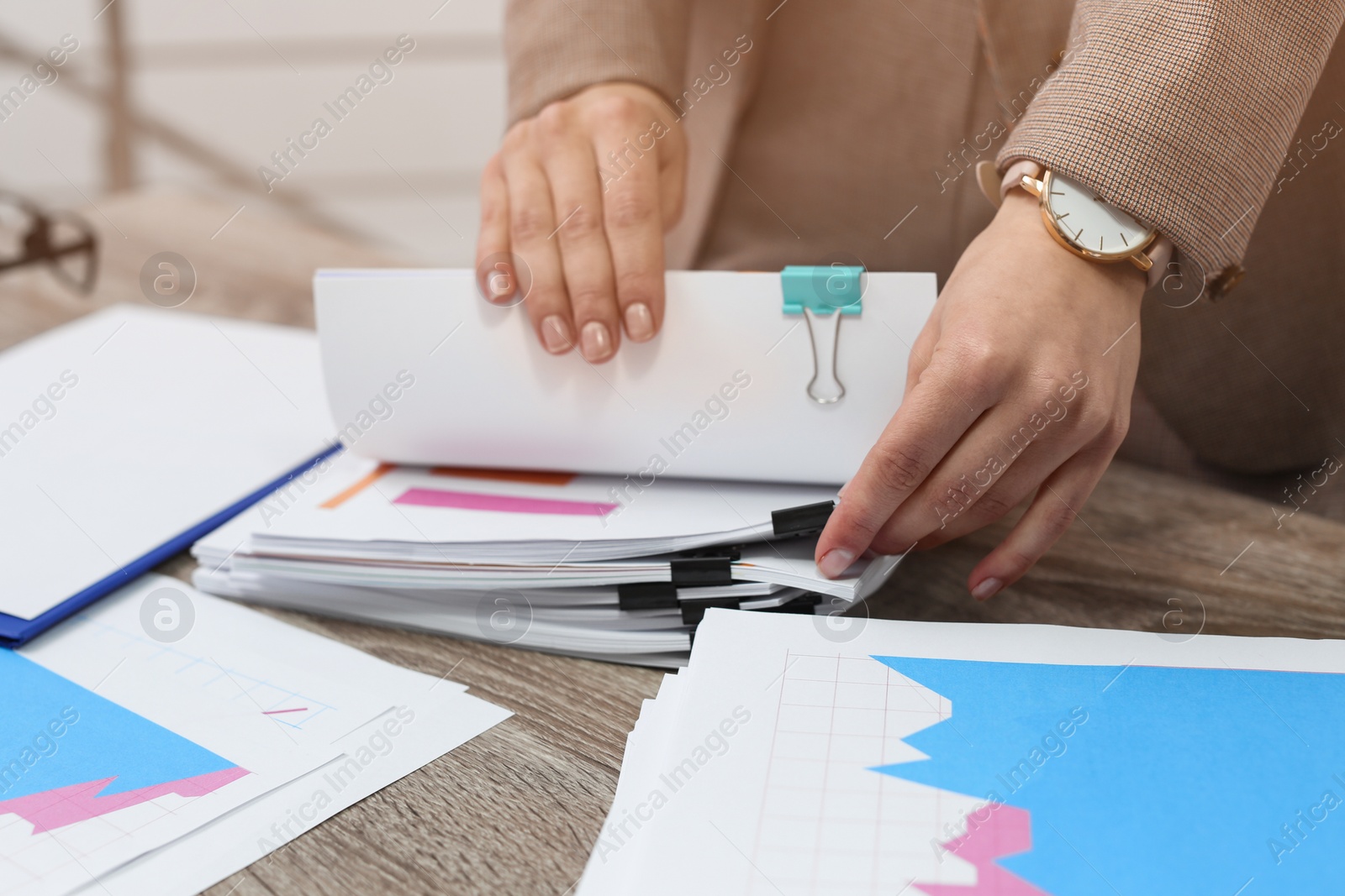 Photo of Businesswoman working with documents at office table, closeup