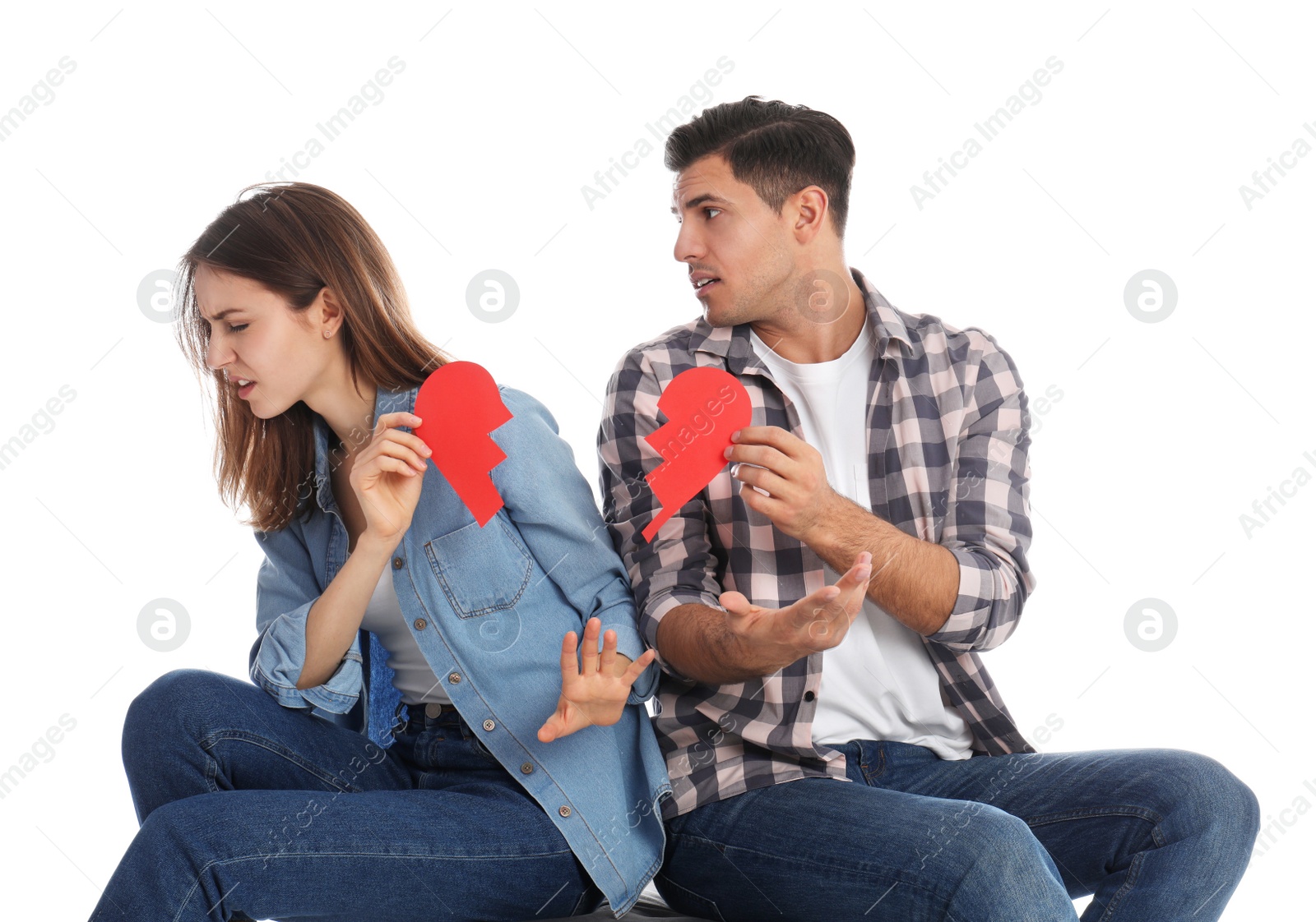 Photo of Couple with torn paper heart on white background. Relationship problems