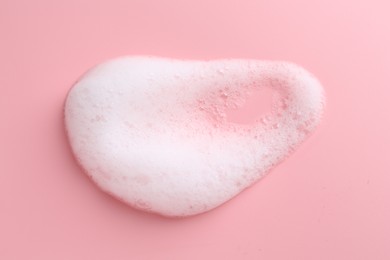 Photo of Sample of fluffy foam on pink background, top view