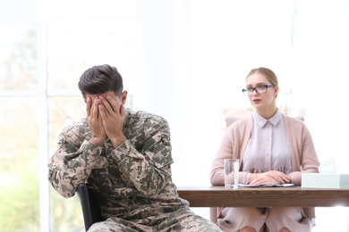 Psychotherapist working with military officer in office