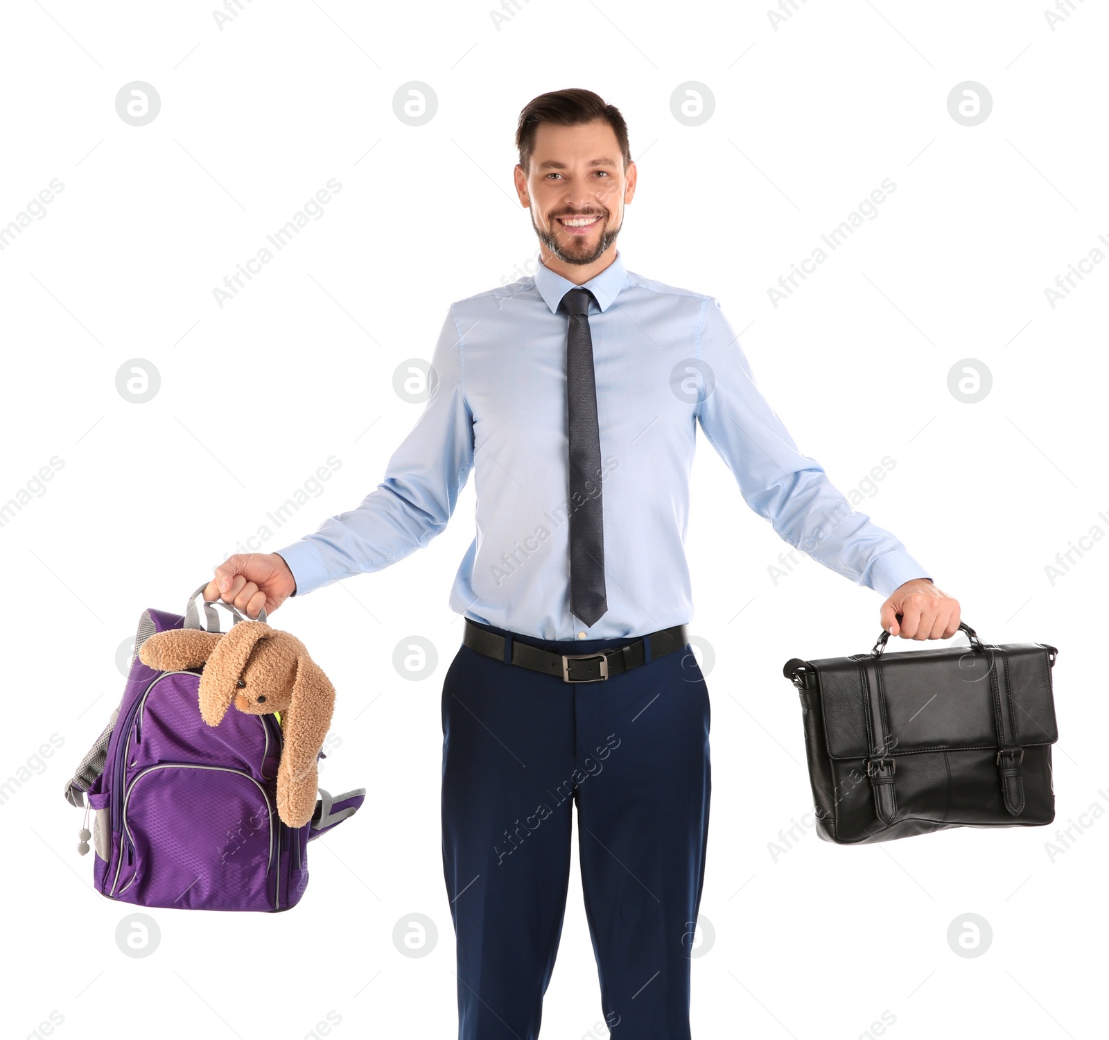 Photo of Portrait of businessman holding backpack with toy and briefcase on white background. Combining life and work