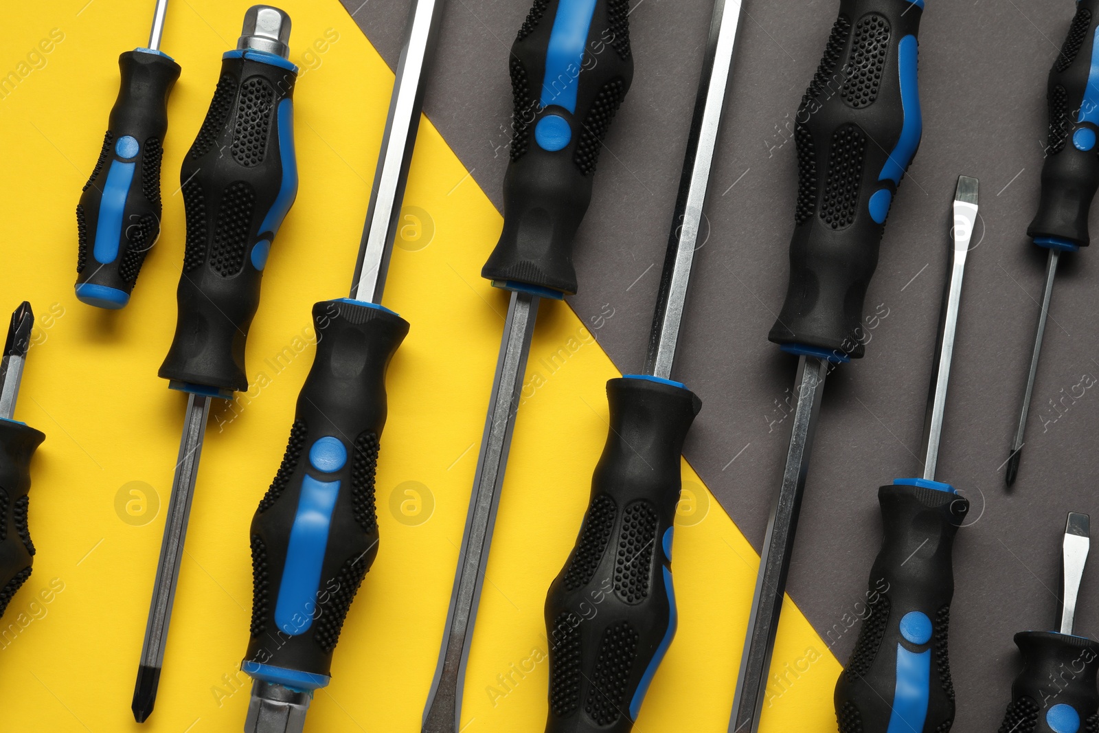 Photo of Set of screwdrivers on color background, flat lay