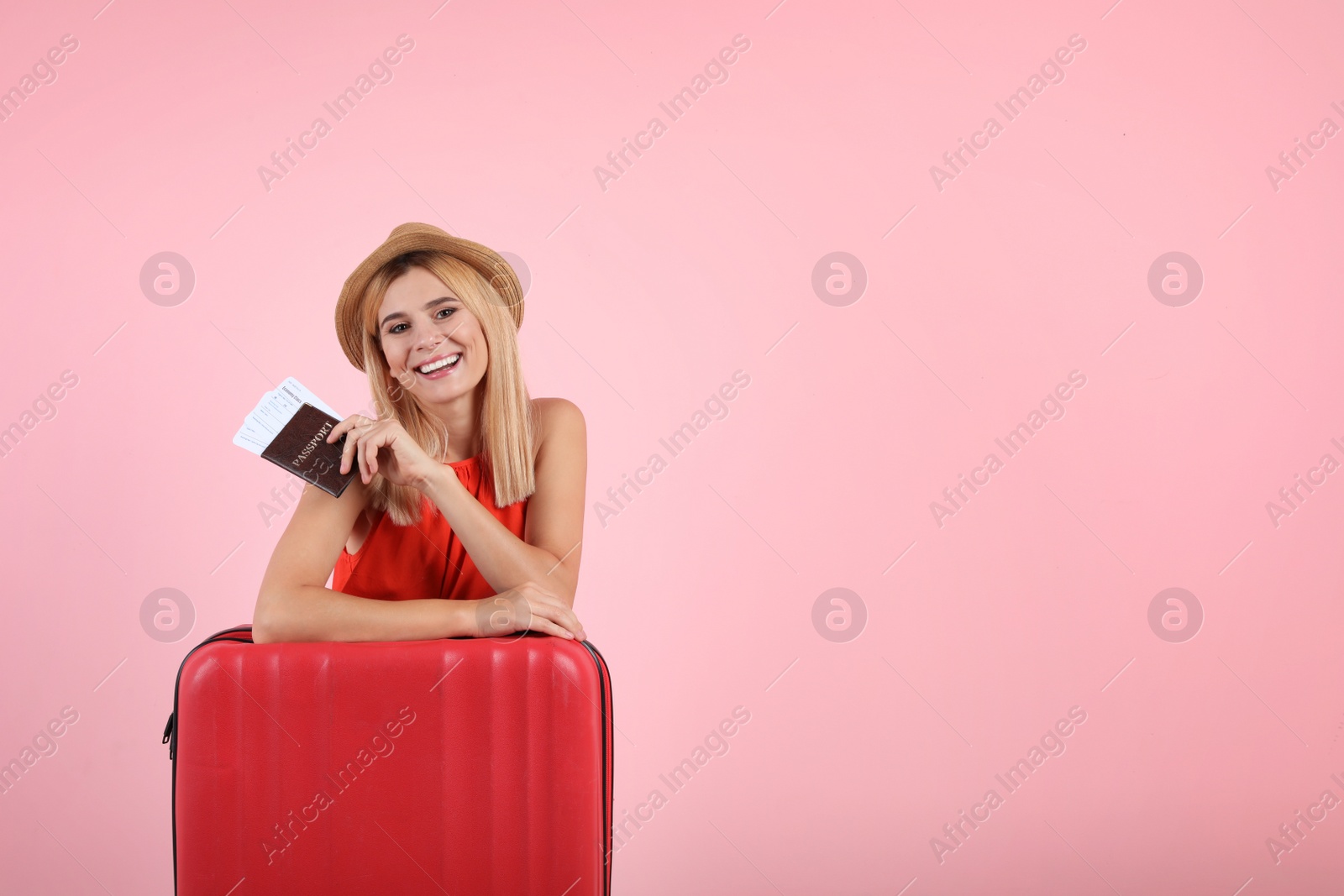 Photo of Woman with suitcase and passport on color background. Space for text