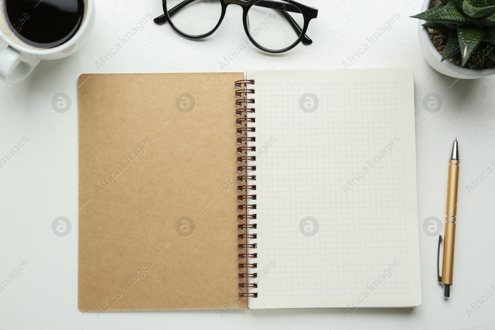 Photo of Flat lay composition with open notebook on white table. Space for text