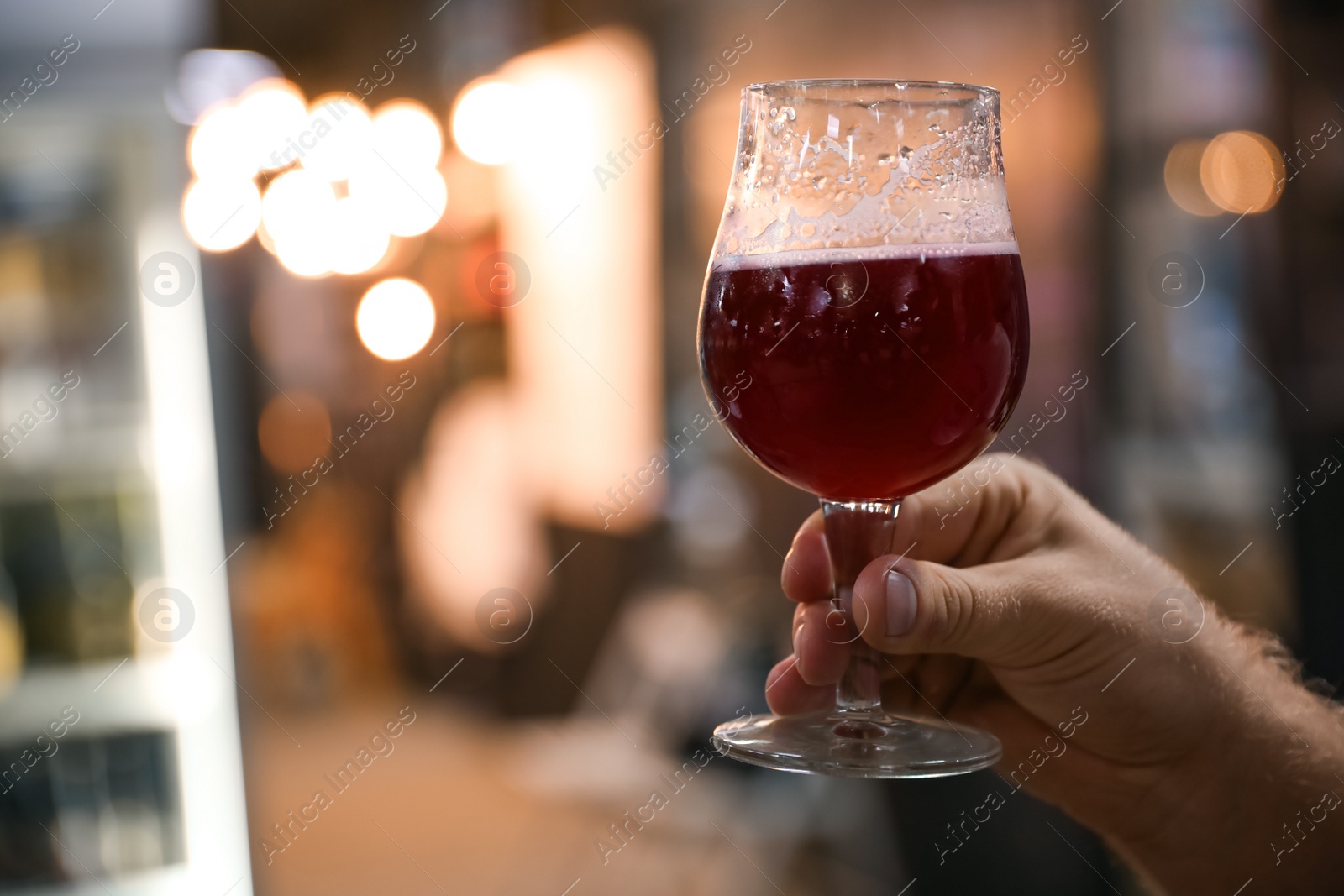 Photo of Man with glass of cold tasty beer at festival, closeup