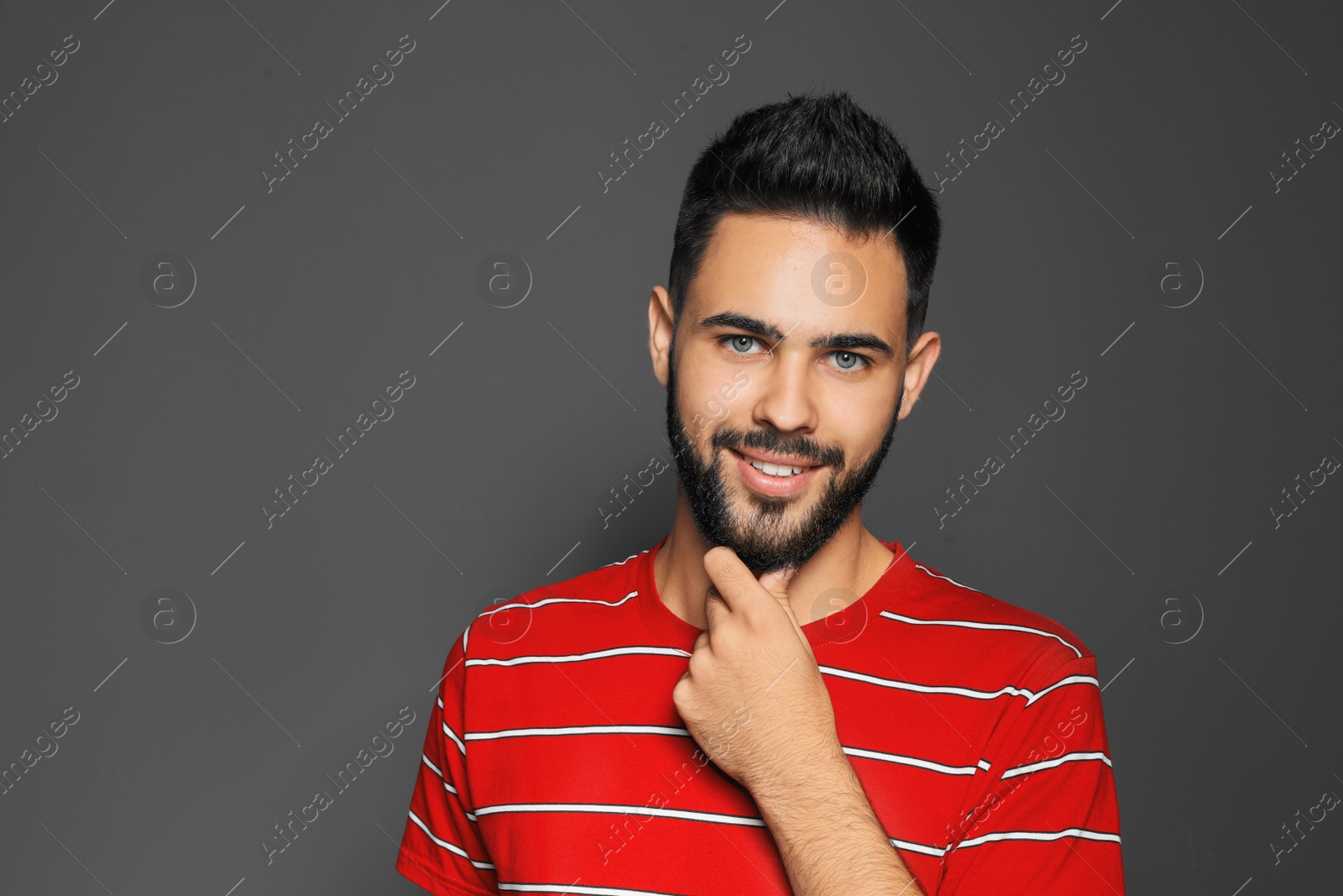 Photo of Portrait of handsome young man on gray background