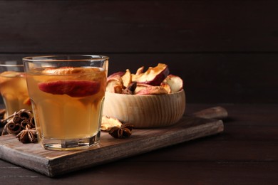 Photo of Delicious compote and ingredients on wooden table, space for text