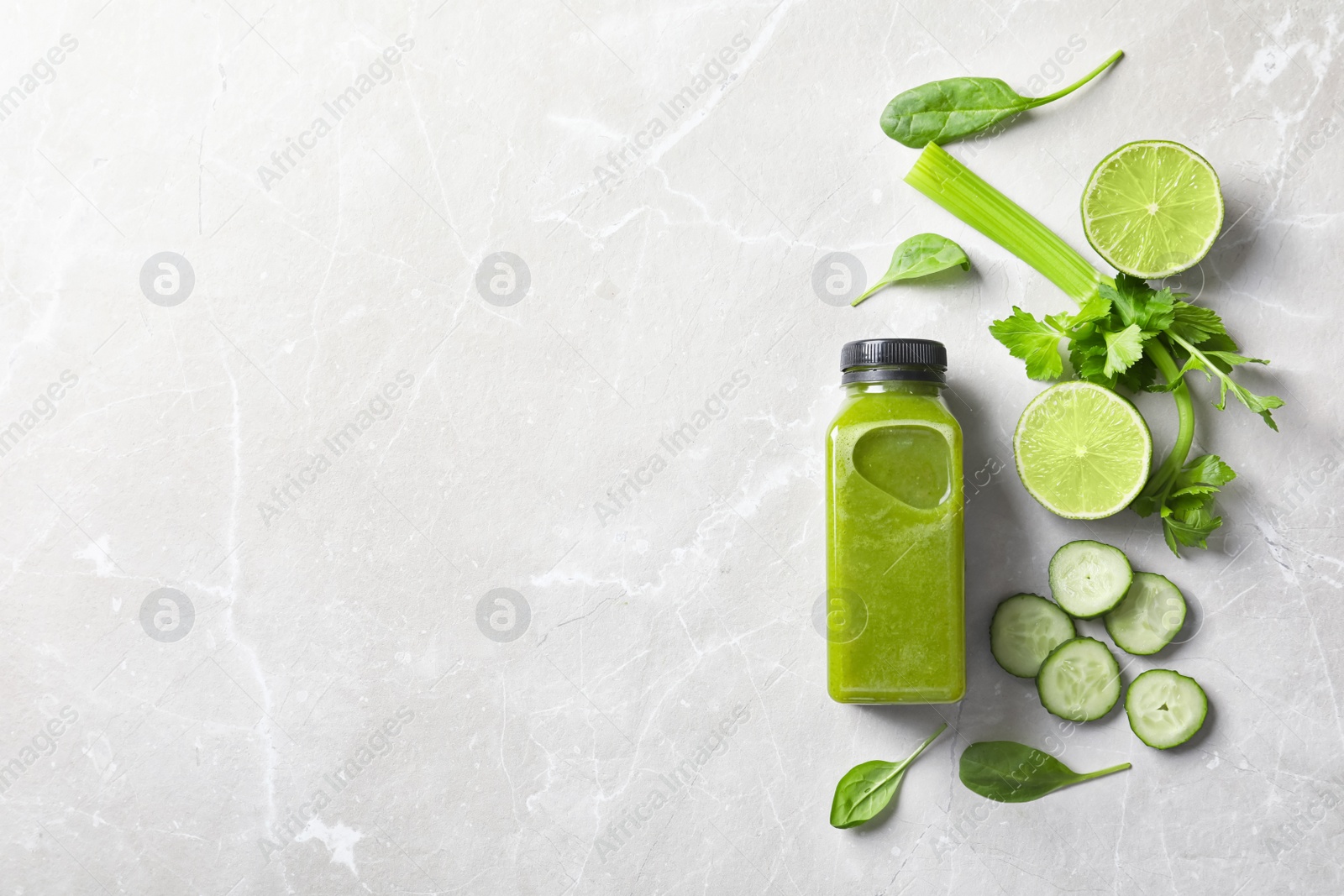 Photo of Flat lay composition with bottle of delicious detox juice and ingredients on light background