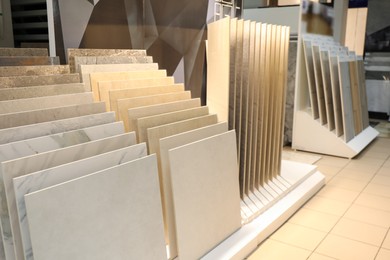 Photo of Assortment of tiles in store. Many different samples indoors