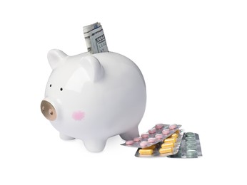 Piggy bank with money and pills on white background. Medical insurance