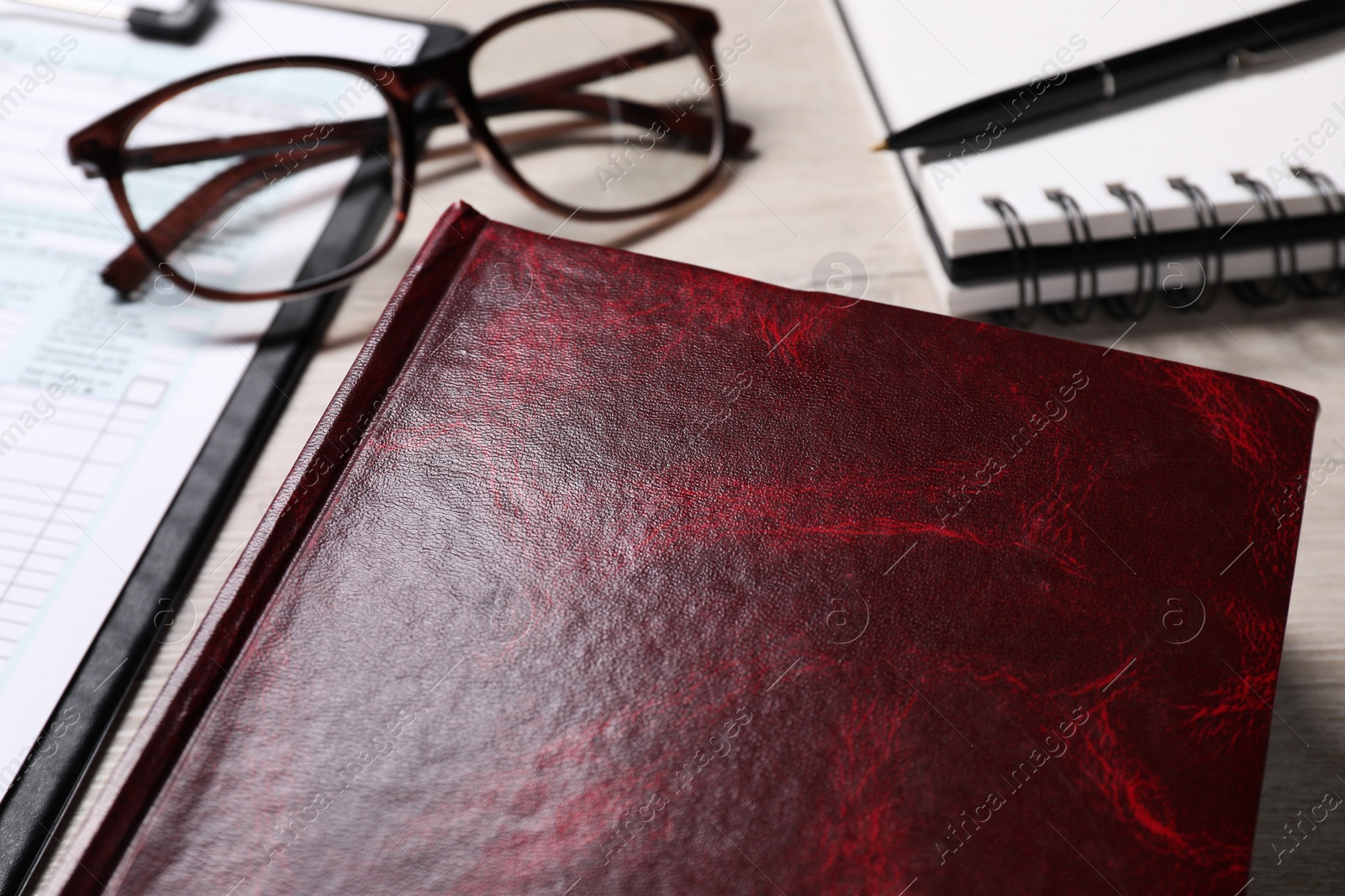 Photo of Law. Book, glasses, form and stationery on table, closeup