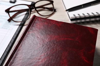 Law. Book, glasses, form and stationery on table, closeup